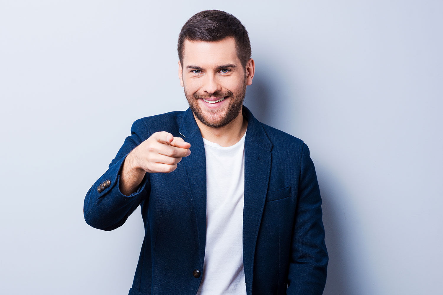 Photo of man smiling point at camera