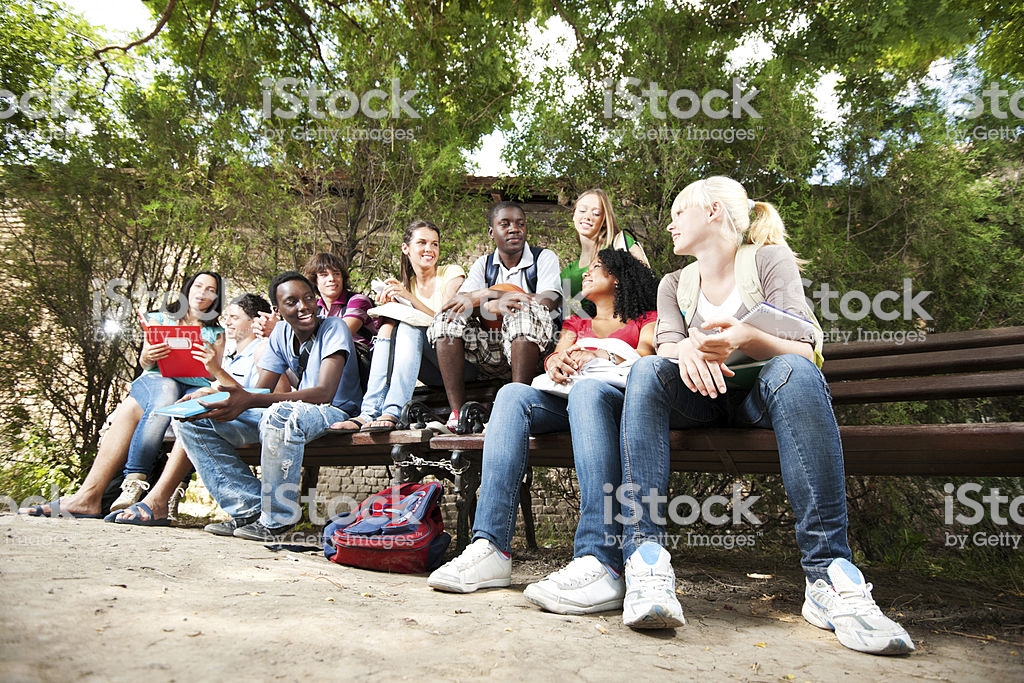 Photo of a group of friends sitting on a bench