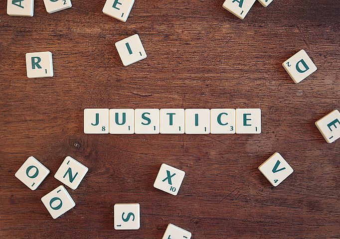 Photo of Justice spelled out in Scrabble pieces