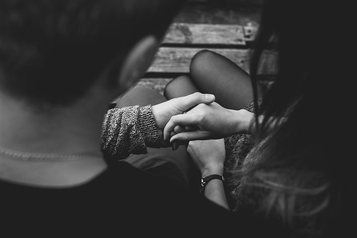 Photo of two people holding hands